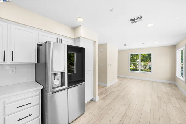 a kitchen with a sink stainless steel appliances and cabinets