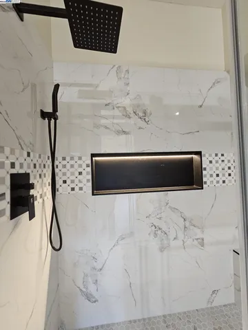 a bathroom with a glass shower door