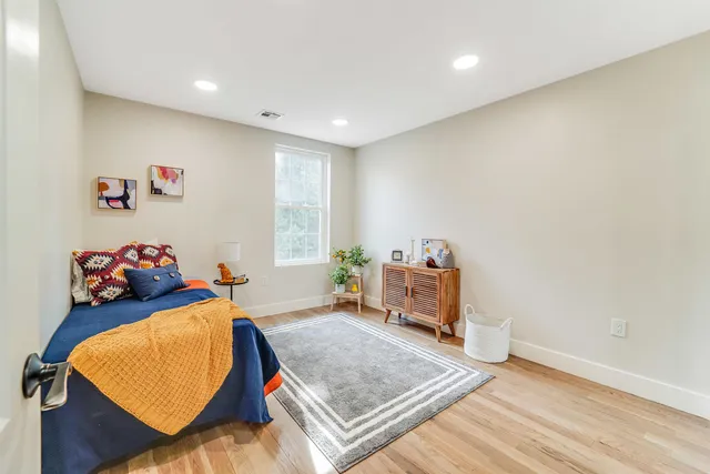 a bedroom with a bed and a lamp