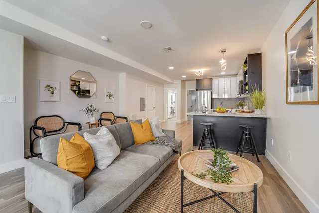 a view of a livingroom with furniture and a potted plant