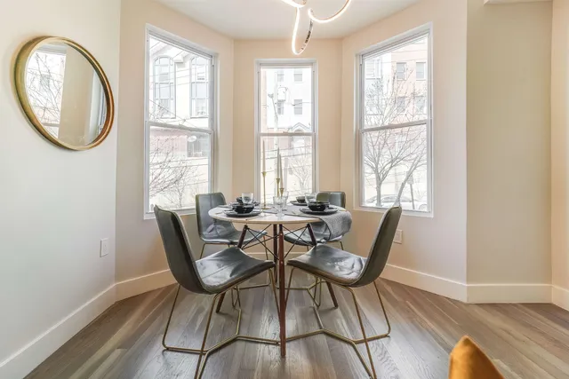 a dining room with furniture a rug and wooden floor