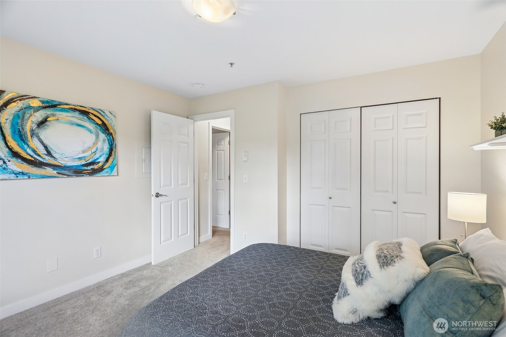18930 Bothell Everett Highway, Unit E301 Bothell, WA 98012 - Photo 17 of 28 a bedroom with a bed and a painting on the wall