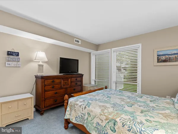 a bedroom with a bed and a television