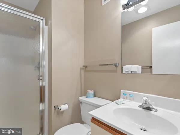 a bathroom with a sink mirror and toilet