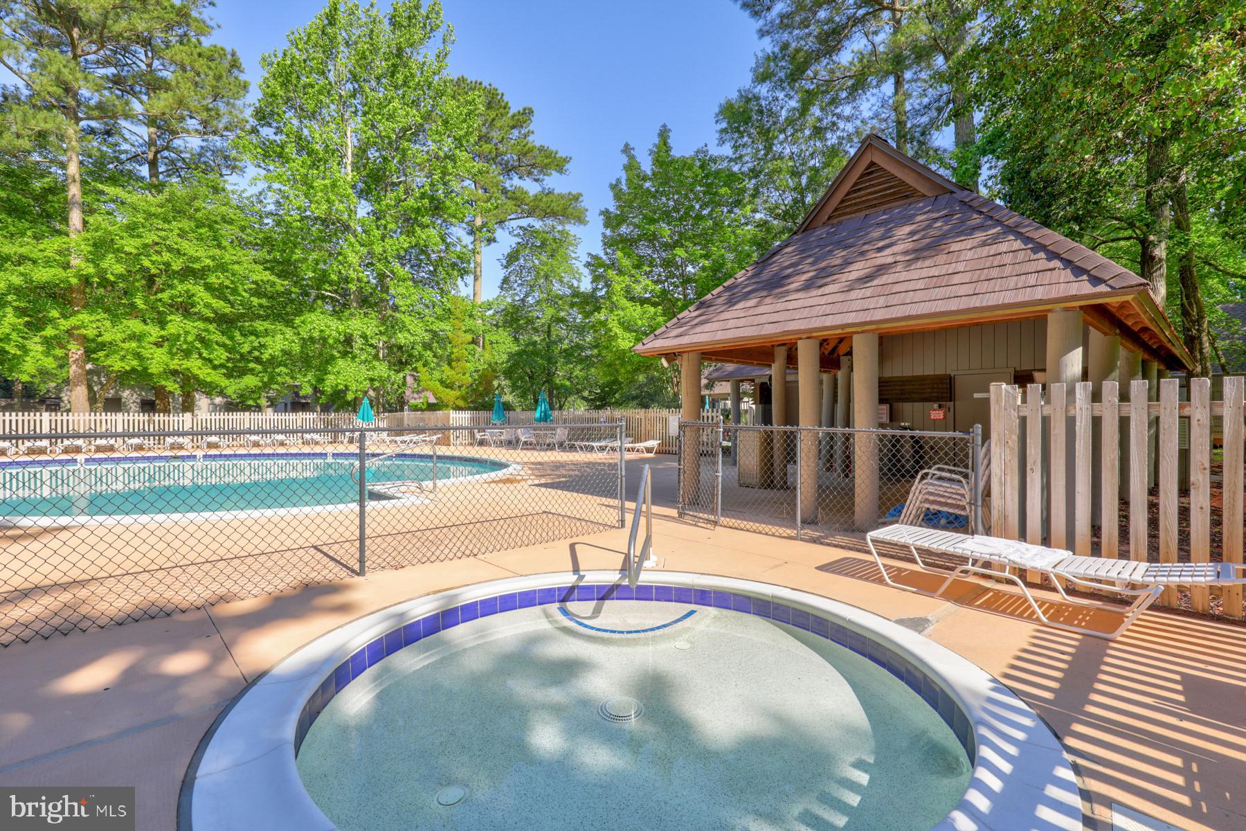 39346 Racquet Lane, Unit 8504 Bethany Beach, DE 19930 - Photo 39 of 40 a view of a house with backyard and sitting area
