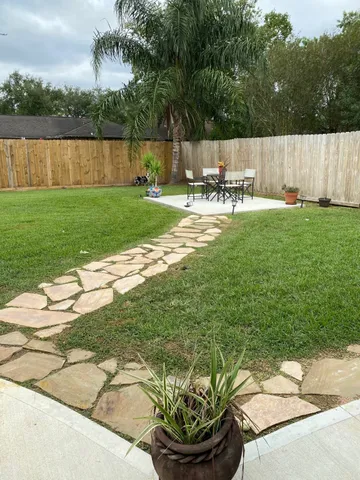 a view of swimming pool with a patio and yard