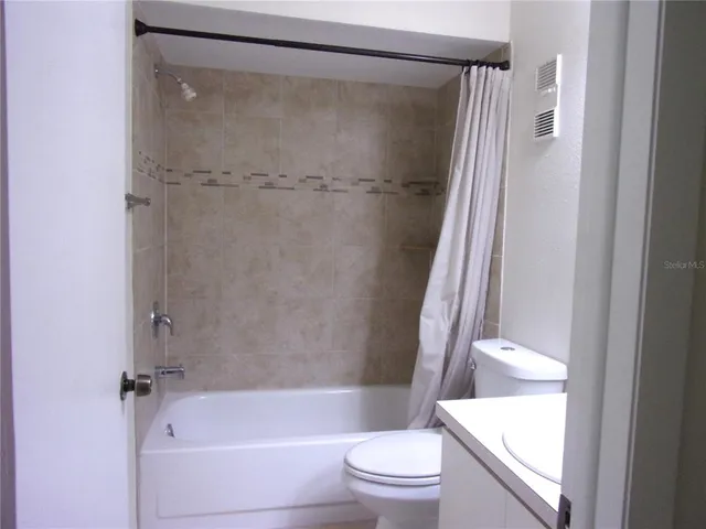 a bathroom with a shower and a toilet