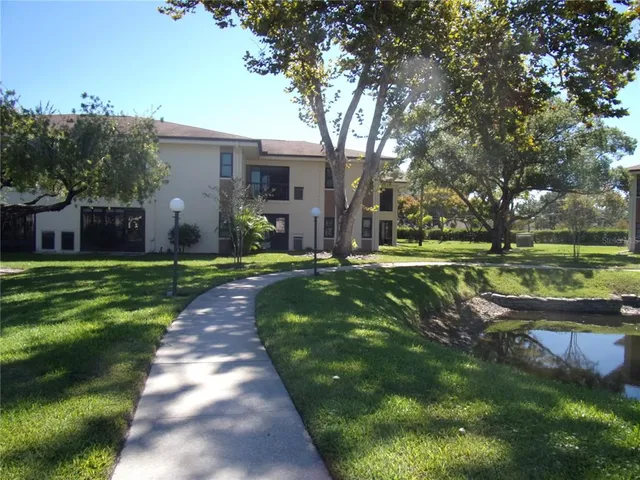a view of a backyard with large trees