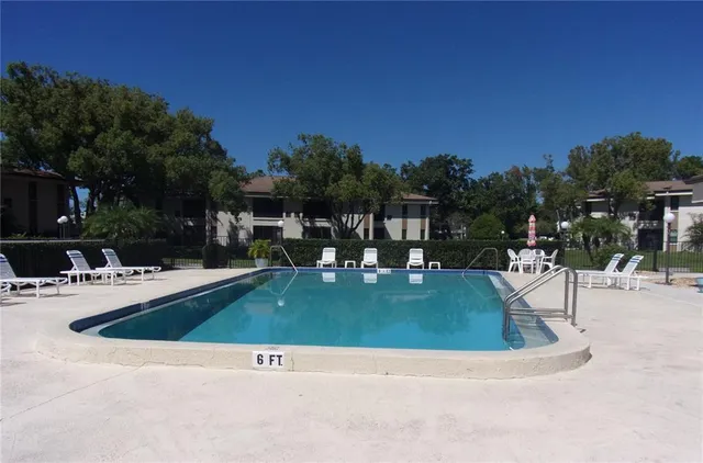 a view of a swimming pool with outdoor seating
