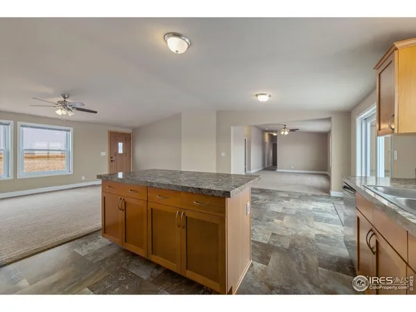a bathroom with a granite countertop sink a mirror and a bathtub