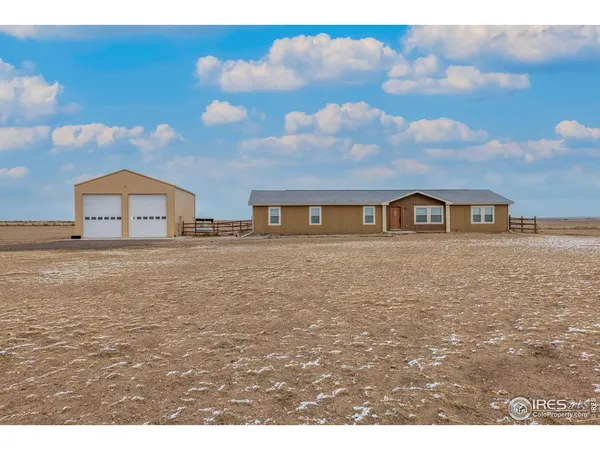 a house view with swimming pool and trees in the background
