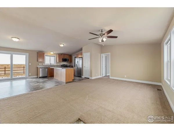 a view of a livingroom with a furniture wooden floor and a kitchen