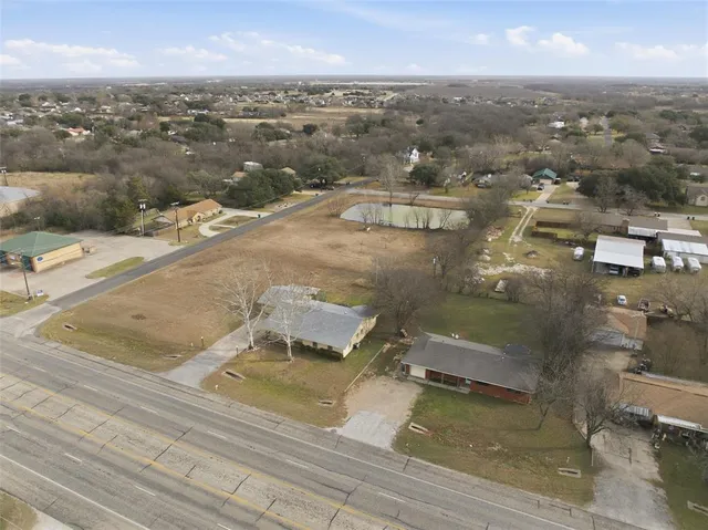 an aerial view of residential houses with outdoor space