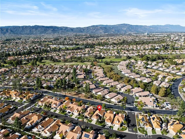 an aerial view of residential houses with city view