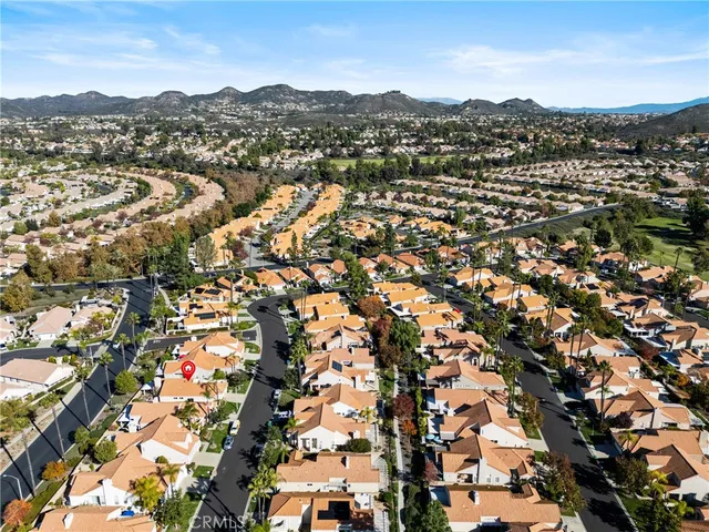 an aerial view of residential houses with city view