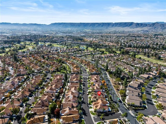 an aerial view of residential house and sandy dunes