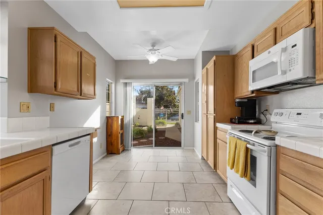 a kitchen with a stove top oven sink and refrigerator