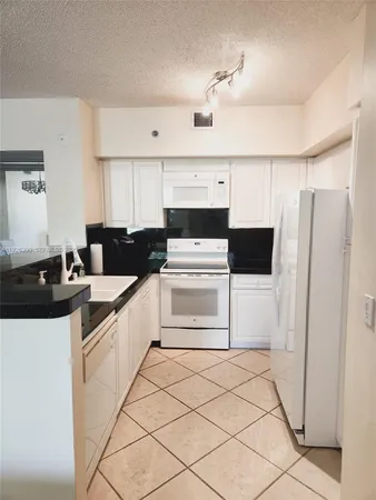 a kitchen with a sink a stove and refrigerator