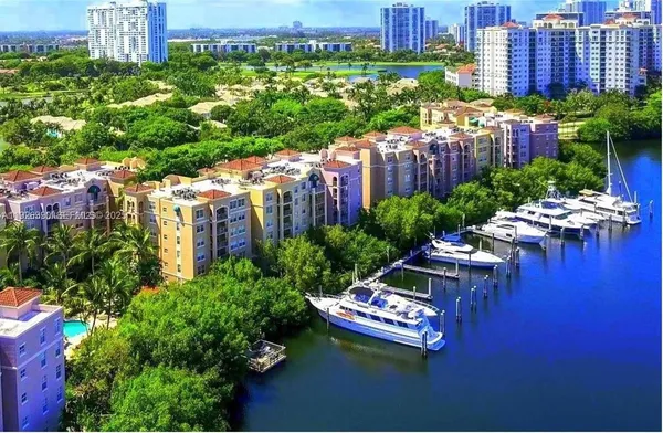 a wooden bench sitting in the middle of a city with tall buildings