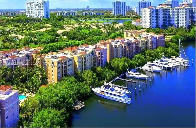 a wooden bench sitting in the middle of a city with tall buildings
