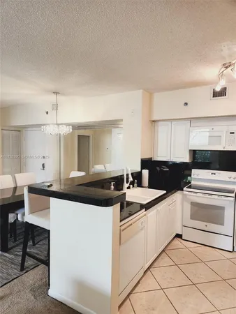 a kitchen with a stove and a sink
