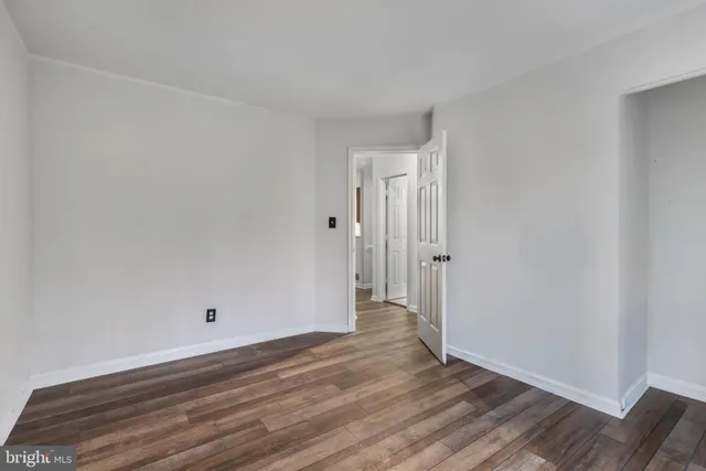 a view of room with wooden floor