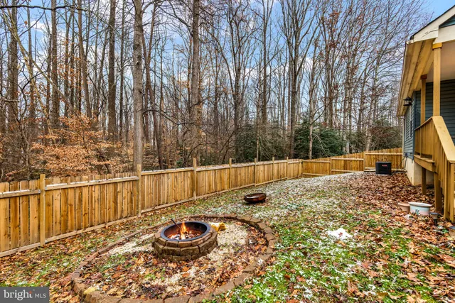 a view of backyard with swimming pool and seating