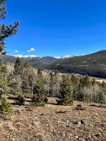 a view of a mountain with a mountain in the background