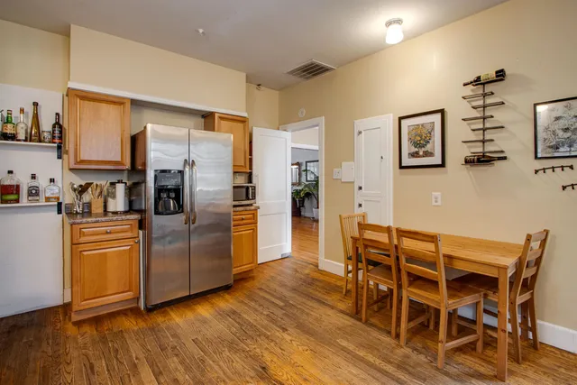 a kitchen with stainless steel appliances wooden floors and refrigerator