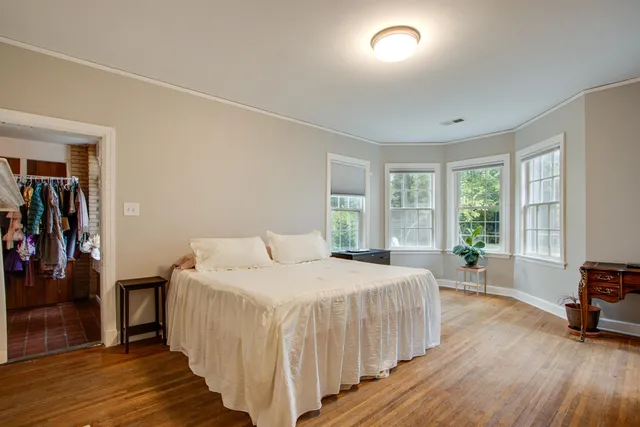 a bedroom with a bed and a large window