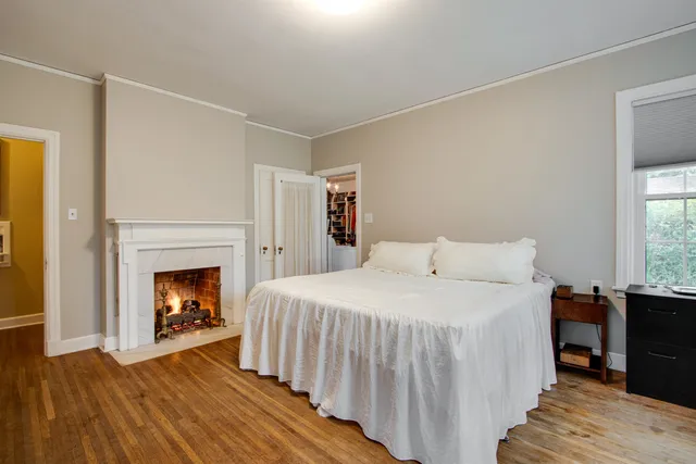 a bedroom with a bed and a fireplace