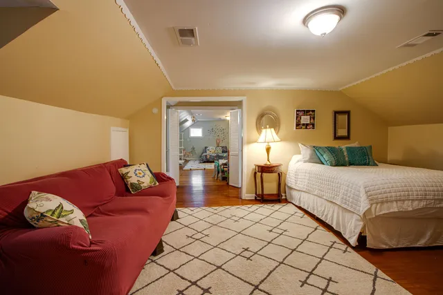 a bedroom with a bed and couch