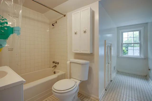 a bathroom with a toilet a sink and shower