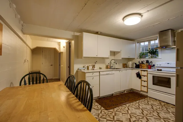 a kitchen with a sink cabinets and appliances