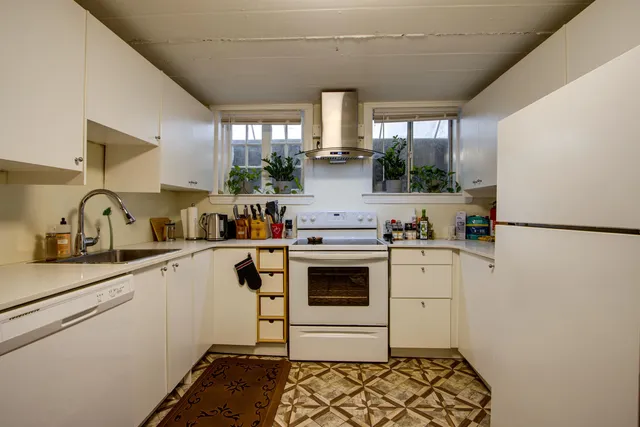 a kitchen with a sink cabinets and stainless steel appliances