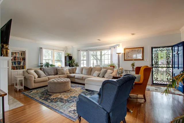 a living room with furniture and a wooden floor