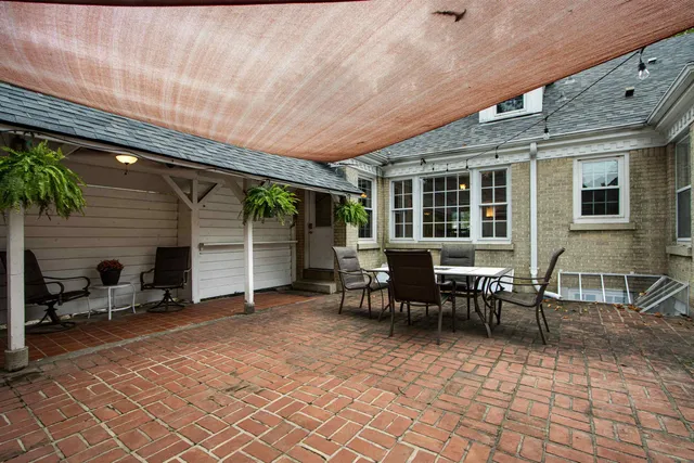 a view of a patio with table and chairs and wooden floor