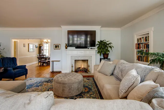 a living room with furniture a flat screen tv and a fireplace