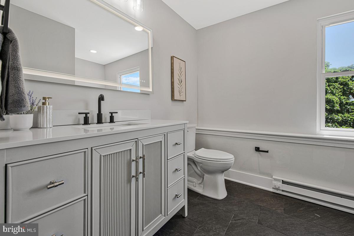 2105 Queens Chapel Road Mount Rainier, MD 20712 - Photo 20 of 33 a bathroom with a toilet sink and mirror