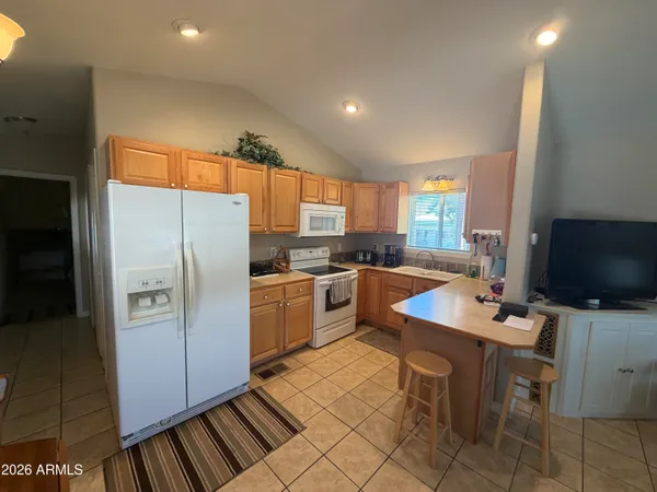 a bedroom with a bed a couch and a painting on the wall