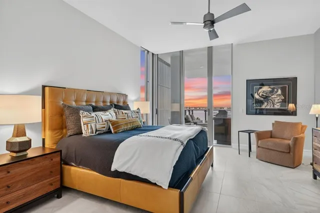 a white bath tub sitting next to a shower