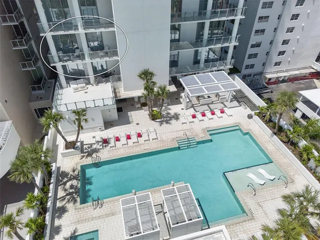 a large white kitchen with kitchen island a stove a sink and cabinets