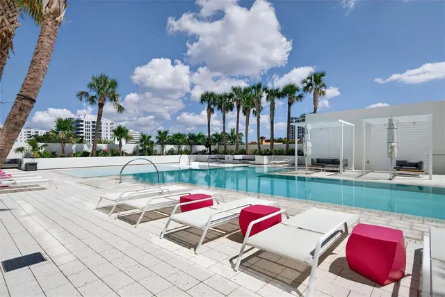 a view of a tall building with a palm tree in the background