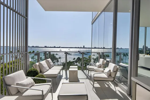 a view of balcony with seating space and city view