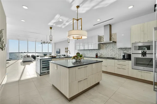 a kitchen with stainless steel appliances a stove sink and cabinets