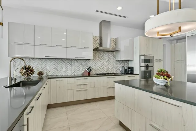 a kitchen with stainless steel appliances granite countertop a sink and cabinets