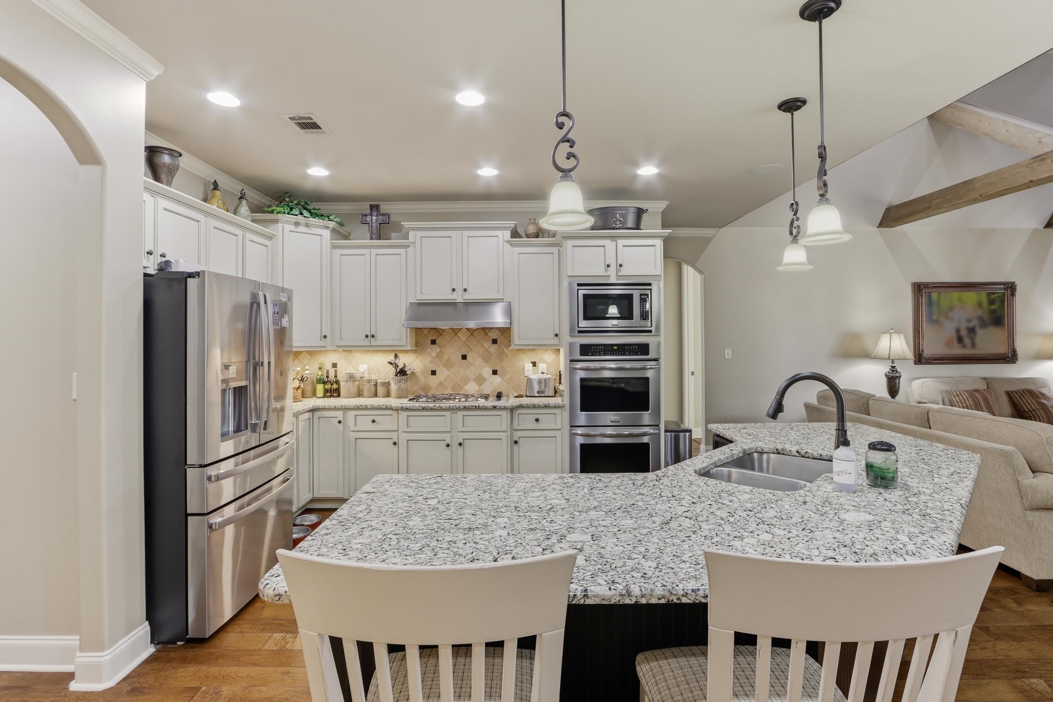 1301 Conser Street Collierville, TN 38017 - Photo 12 of 40 a kitchen with stainless steel appliances granite countertop a sink refrigerator and cabinets