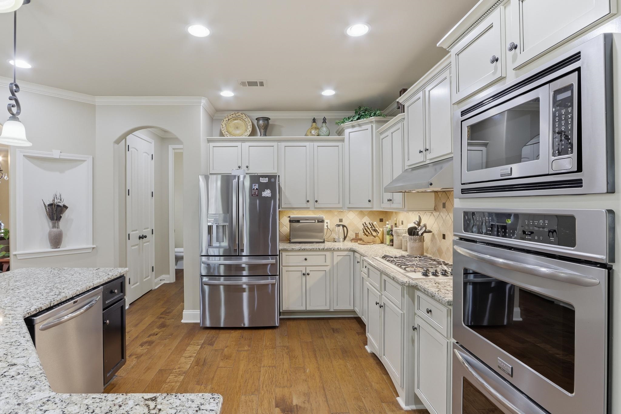 1301 Conser Street Collierville, TN 38017 - Photo 14 of 40 a kitchen with stainless steel appliances a stove a sink and a refrigerator