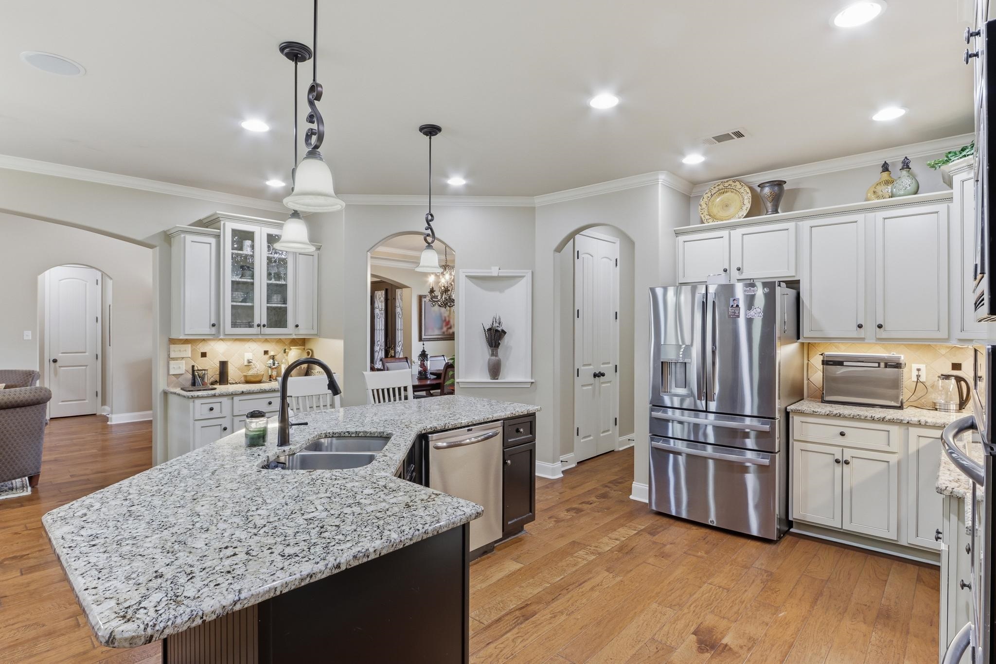 1301 Conser Street Collierville, TN 38017 - Photo 15 of 40 a kitchen with stainless steel appliances granite countertop a sink refrigerator and cabinets