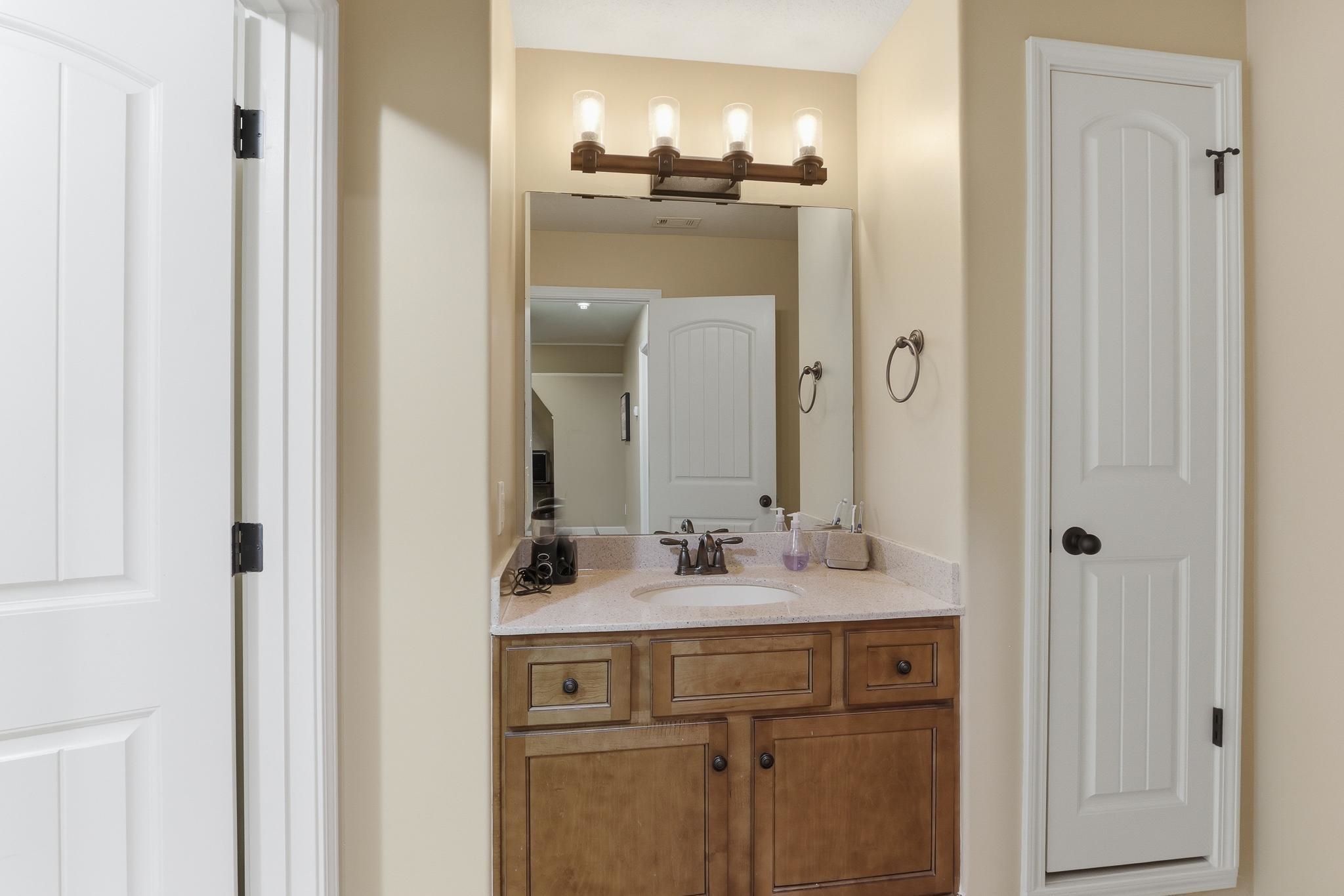 1301 Conser Street Collierville, TN 38017 - Photo 22 of 40 a bathroom with a double vanity sink and a mirror